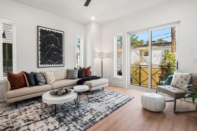 Living room with ceiling fan and light wood-type f