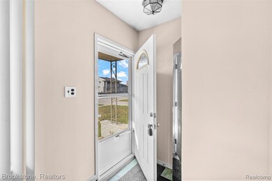 Doorway to outside with a textured ceiling