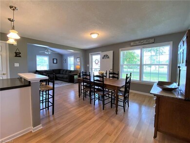 Open living room, dining, and kitchen