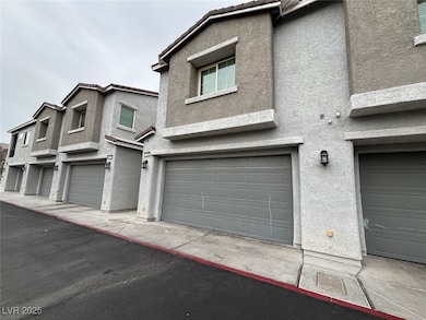 View of front of property with stucco siding, an attached garage, and a tile roof