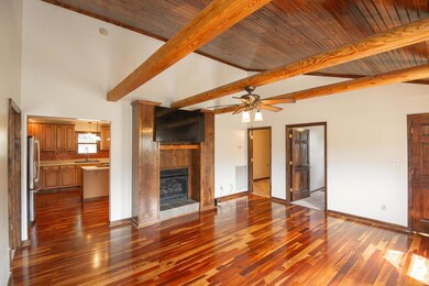 Great Room with Fireplace, Beautiful Wood Cathedral Ceiling, Gorgeous Cherry Hardwood Floors & Wood Beams