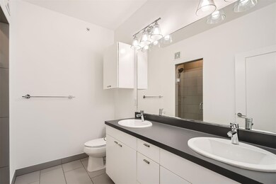 Full bath featuring toilet, double vanity, tile p