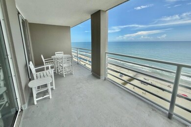 Balcony with view of water and beach