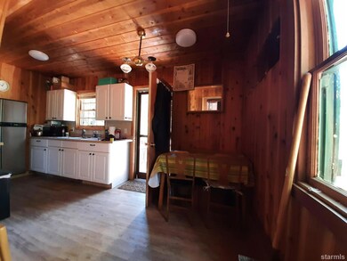 Kitchen and dining area with stairs folded up