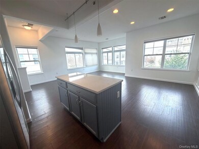 Kitchen featuring recessed lighting, hanging light fixtures, a kitchen island, open floor plan, and light countertops
