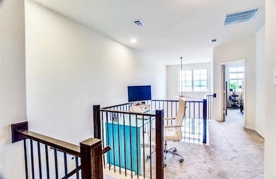 Hall featuring carpet floors and an upstairs landing