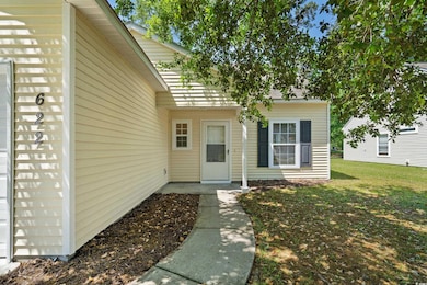 View of exterior entry with a lawn