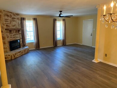 Unfurnished living room with ceiling fan with nota