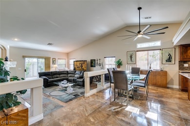 Living area with ceiling fan, high vaulted ceiling