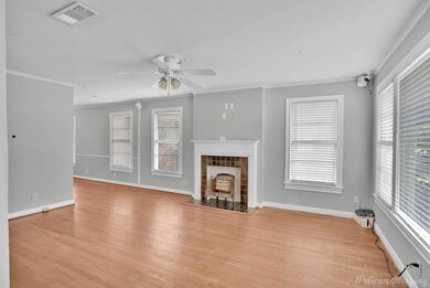 Unfurnished living room with ornamental molding, l