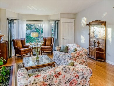 LIVING ROOM HAS CATHEDRAL CEILINGS, FIREPLACE WITH CUSTOM MANTEL & WOOD FLOORS.