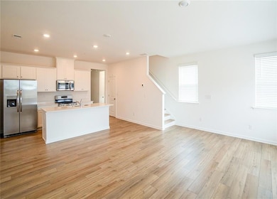 Kitchen with stainless steel appliances, white cab