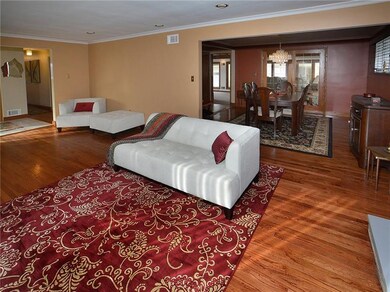 The living room is open and airy and extends into the dining room.  Gleaming original hardwood floors are found throughout the home, although 2 bedrooms are carpeted.