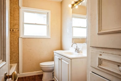 Full bathroom featuring hardwood / wood-style floo