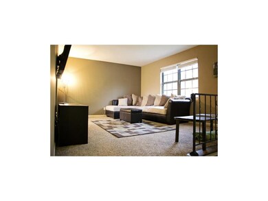 Spacious living room with large front window.