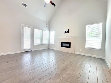 Unfurnished living room featuring a ceiling fan, 