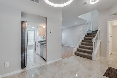 Kitchen featuring white cabinets, appliances with 