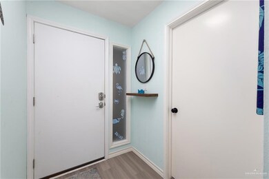 Entryway with wood finished floors and baseboards