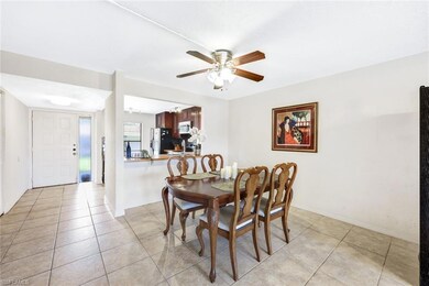 Dining room with ceiling fan and light tile patter