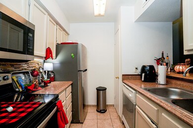 A galley style kitchen with newer appliances. Does