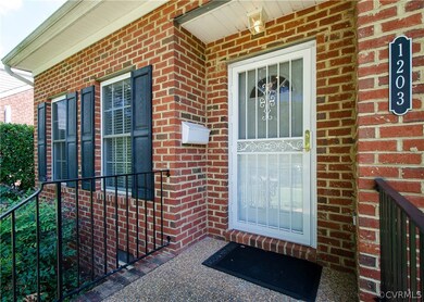 The front entrance has a decorative storm door and covered stoop.