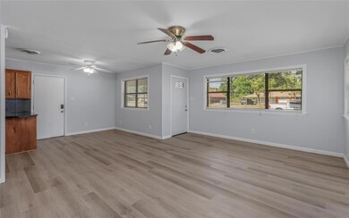 Front living room featuring ceiling fan, light woo