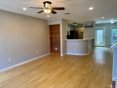 Unfurnished living room featuring a ceiling fan, 