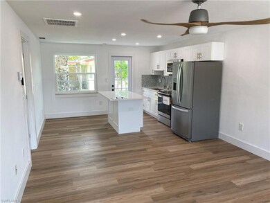 Kitchen featuring white cabinets, sink, appliances