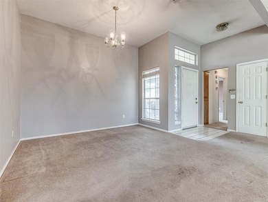 Foyer entrance featuring light colored carpet, a t