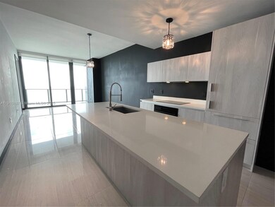 Light quartz countertops and Italian cabinetry