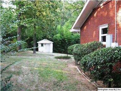 Level side yard with playhouse