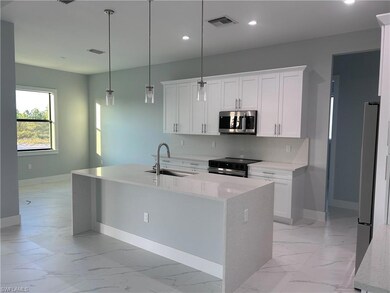 Kitchen with a sink, stainless steel appliances, l