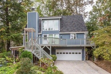 Nestled in the woods with beautiful landscaping, no need to bring your lawn mower