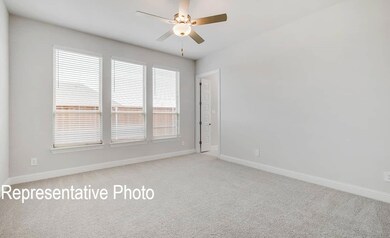 Carpeted empty room featuring ceiling fan