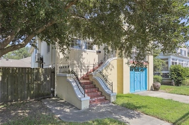 Charming stairwell leads to the main level of the house.  Backyard entrance through the gate.