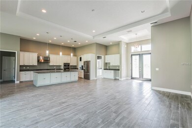 View of great room, kitchen and foyer.