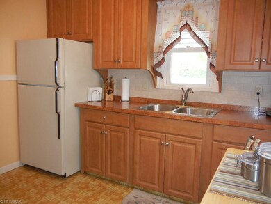 Beautifully updated kitchen with newer cabinets and ceramic tile back splash! Refrigerator and stove included!