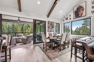 Dining area with beamed ceiling, light wood finished floors, high vaulted ceiling, and recessed lighting