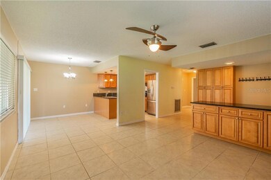 Open living and dining space with custom, solid wood built in cabinetry for storage.
