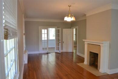 The living room has beautiful hardwood flooring, d