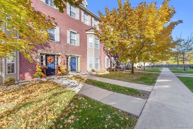 Colonial house with brick siding and a front lawn