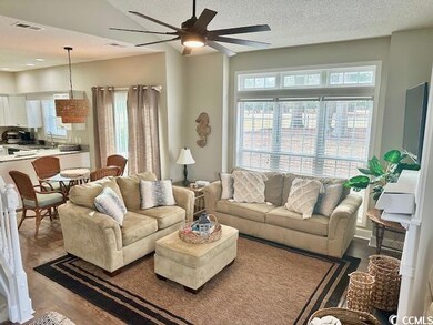 Living area with a textured ceiling, visible vents