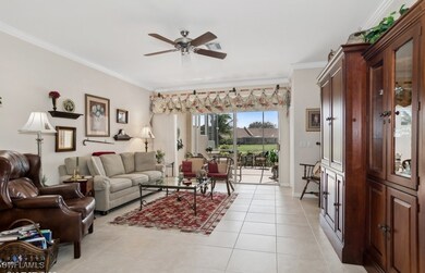 Tiled living room with ceiling fan and ornamental