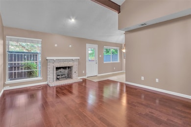 Unfurnished living room featuring a fireplace, wo