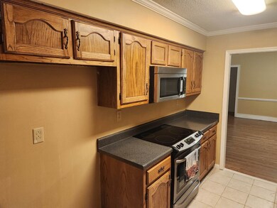 Kitchen featuring crown molding, light tile patter