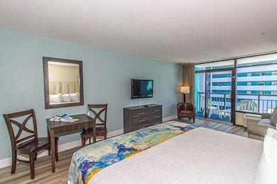 Bedroom featuring access to outside, multiple windows, and light hardwood / wood-style floors