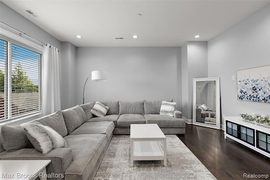 Living room featuring wood finished floors and recessed lighting