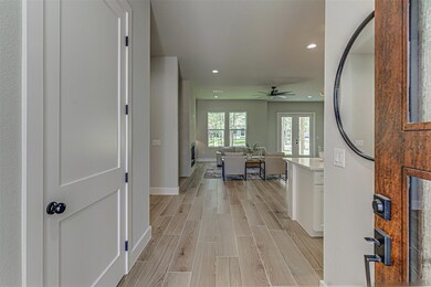 Hall featuring baseboards, recessed lighting, and