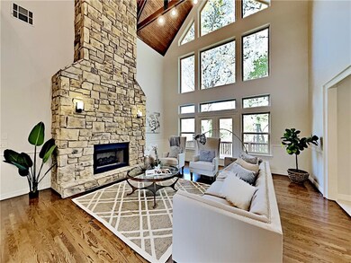 Gorgeous stone fireplace goes all the way to the ceiling. Beautiful windows make the the showcase of the home!