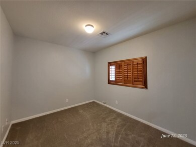 Empty room with dark carpet and baseboards